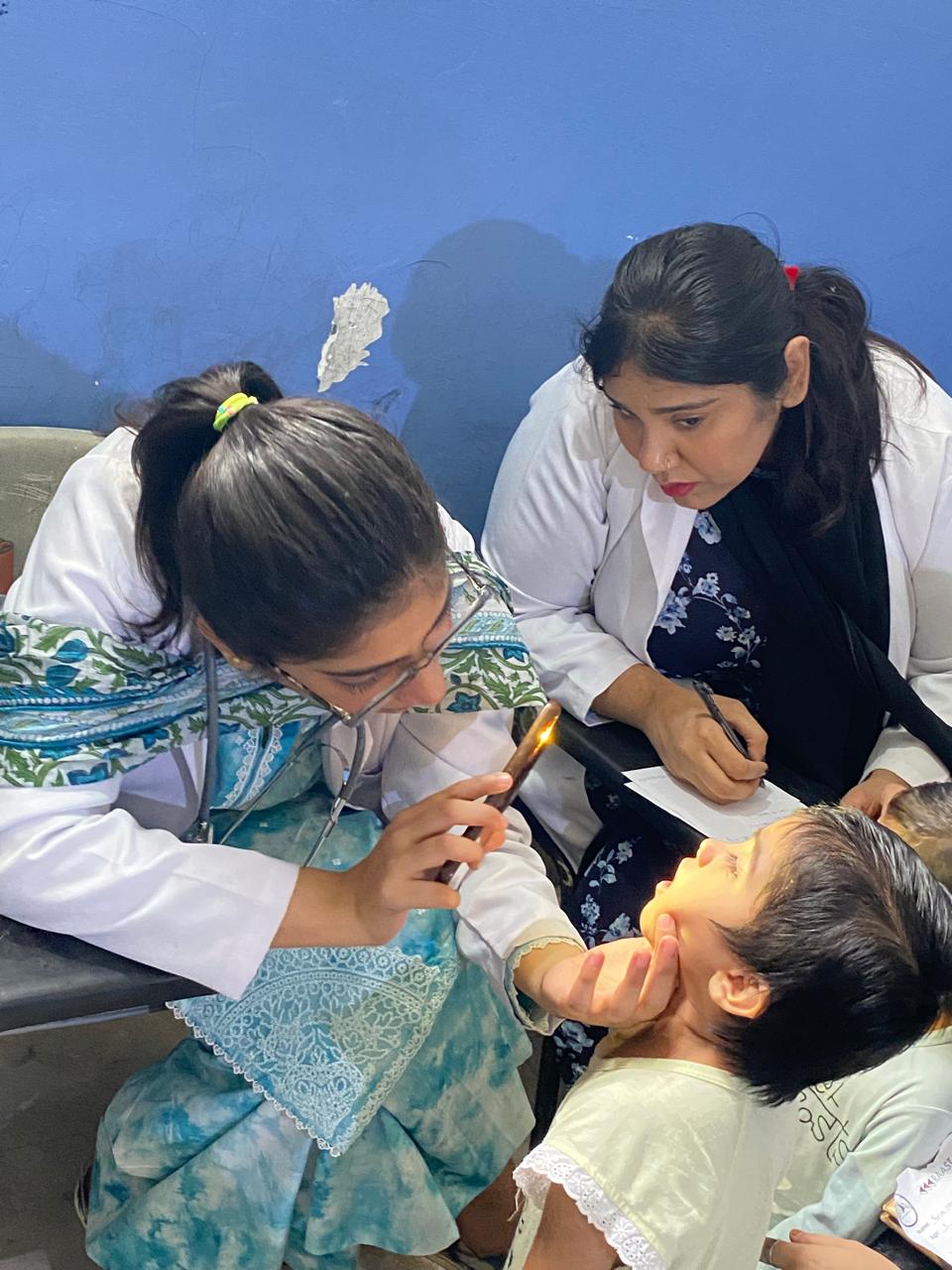 Raastah medical camp — doctor treating a child